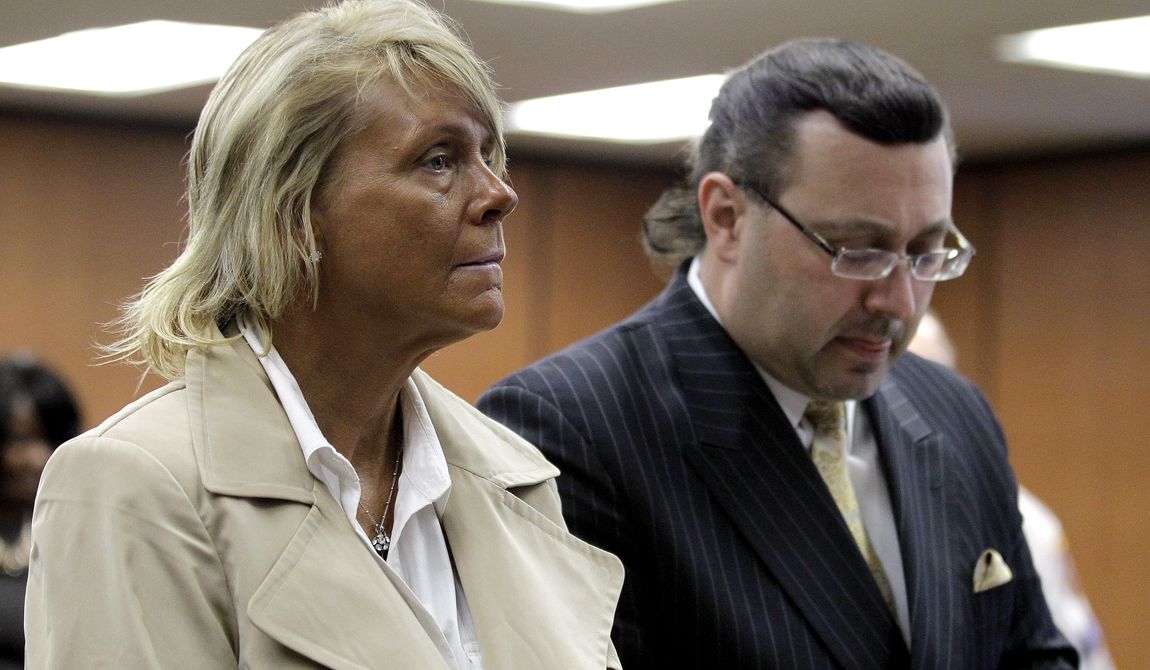 Patricia Krentcil (left), 44, stands May 2, 2012, with her lawyer John Caruso during a court appearance on charges of child endangerment at the Essex County Superior Court in Newark, N.J. Krentcil is accused of taking her 5-year-old child into a tanning booth. (Associated Press) **FILE**