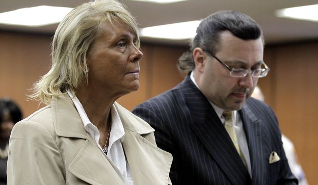 Patricia Krentcil (left), 44, stands May 2, 2012, with her lawyer John Caruso during a court appearance on charges of child endangerment at the Essex County Superior Court in Newark, N.J. Krentcil is accused of taking her 5-year-old child into a tanning booth. (Associated Press) **FILE**
