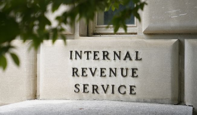 A sign outside the Internal Revenue Service building in Washington, on May 4, 2021. The IRS plans to test-drive a new electronic free-file tax return system next year. Supporters and critics of the idea are mobilizing to sway the public and Congress over whether the government should set up a program to help people file their taxes without needing to pay somebody else to figure out what they owe. (AP Photo/Patrick Semansky, File)