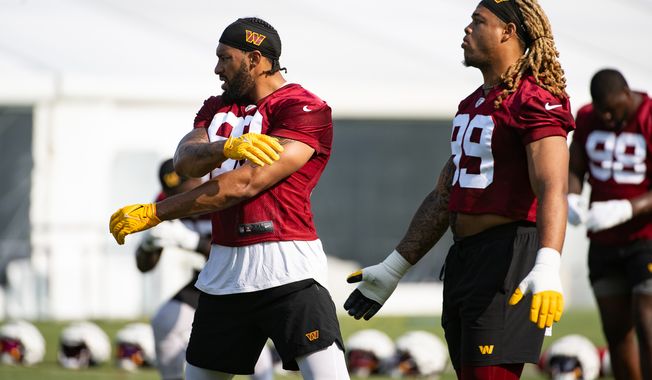 Washington Commanders defensive ends Montez Sweat (90) and Chase Young (99) loosen up during the first day of training camp at the OrthoVirginia Training Center at Commanders Park in Ashburn, Virginia, July 27, 2023. (Photo by Brian Murphy)