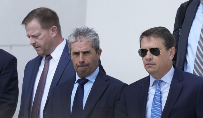 Carlos De Oliveira, center, the property manager of Donald Trump&#x27;s Mar-a-Lago estate, leaves the Alto Lee Adams Sr. U.S. Courthouse, Aug. 10, 2023, in Fort Pierce, Fla. (AP Photo/Wilfredo Lee, File)