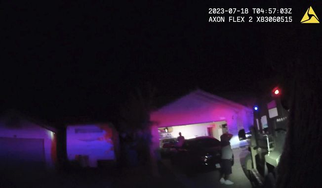 In this Monday evening, July 17, 2023 image taken from police body camera video provided by the Las Vegas Metropolitan Police Department, an unidentified man and woman are seen as SWAT officers raided a home in the nearby city of Henderson, Nev., in connection with the 1997 killing of rapper Tupac Shakur near the Las Vegas Strip. (Las Vegas Metropolitan Police Department via AP)