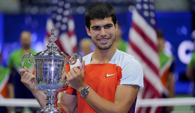 Carlos Alcaraz, of Spain, holds up the championship trophy after defeating Casper Ruud, of Norway, in the men&#x27;s singles final of the U.S. Open tennis championships, Sunday, Sept. 11, 2022, in New York. Total prize money and player compensation at this year’s U.S. Open tennis tournament will reach a record $65 million, the U.S. Tennis Association said Tuesday, Aug. 8, 2023, noting that number is boosted by increases in the amount of expenses covered.(AP Photo/Charles Krupa, File)