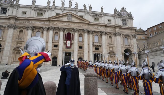 Swiss Guards march in front of St. Peter&#x27;s Basilica at the Vatican, Saturday, Dec. 25, 2021. (AP Photo/Gregorio Borgia)