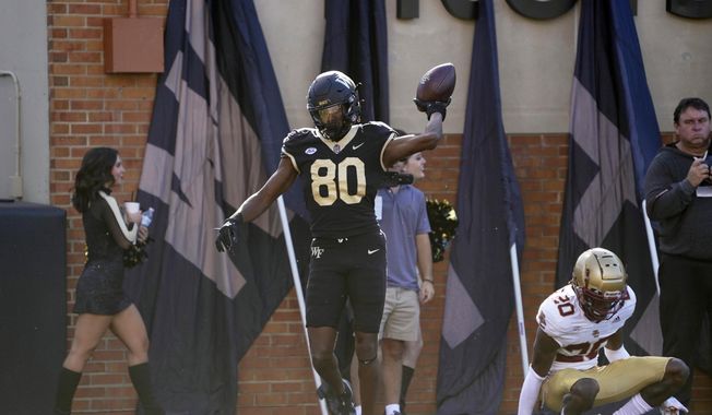 Wake Forest wide receiver Jahmal Banks (80) celebrates his touchdown catch against Boston College during the first half of an NCAA college football game in Winston-Salem, N.C., Oct. 22, 2022. Wake Forest opens the season against Elon on Aug. 31, 2023. (AP Photo/Chuck Burton, File)