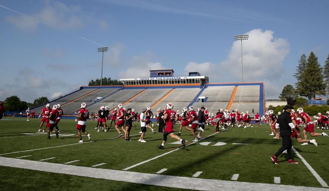The Wisconsin football team warms up during the second day of football training camp at UW-Platteville in Platteville, Wis., Thursday, Aug. 3, 2023. (Samantha Madar/Wisconsin State Journal via AP)