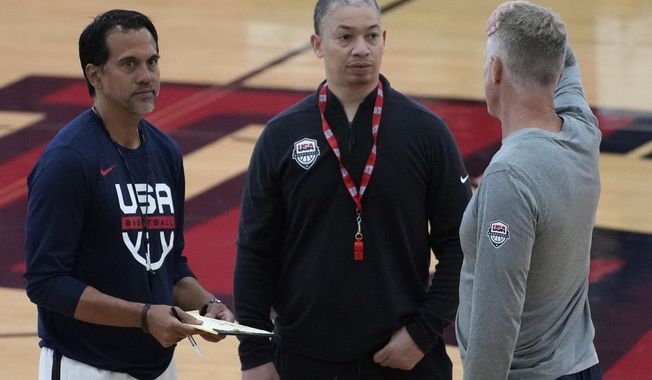 FILE - From left, coaches Erik Spoelstra of the Miami Heat, Tyronn Lue of the Los Angeles Clippers and Steve Kerr of the Golden State Warriors speak at a practice during training camp for the United States men&#x27;s basketball team Thursday, Aug. 3, 2023, in Las Vegas. Lue was supposed to play for his country in 1997, before an injury left him flying home from Australia alone and unable to be part of the FIBA 22 &amp; Under World Championship. He’s finally wearing the red, white and blue again, as an assistant coach under Steve Kerr for this year’s U.S. World Cup team. (AP Photo/John Locher, File)