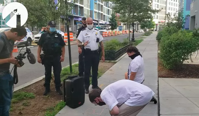 In this file photo, Metropolitan Police Department officers are shown in this video screen capture, just before they arrest two pro-life demonstrators with Students for Life of America in Northeast D.C. on August 1, 2020. The demonstrators were chalking the public sidewalk Saturday morning, an act an officer in the video said violated a law against defacing public property. On Nov. 18, 2020, Students for Life of America and the Frederick Douglass Foundation filed a lawsuit in federal court asking a judge to declare the city&#x27;s defacement ordinance unconstitutional. (Video courtesy of Students for Life of America)  **FILE**